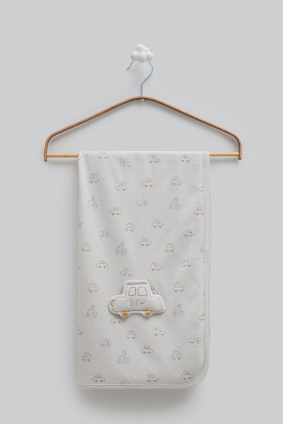 Soft baby blanket on a wooden hanger